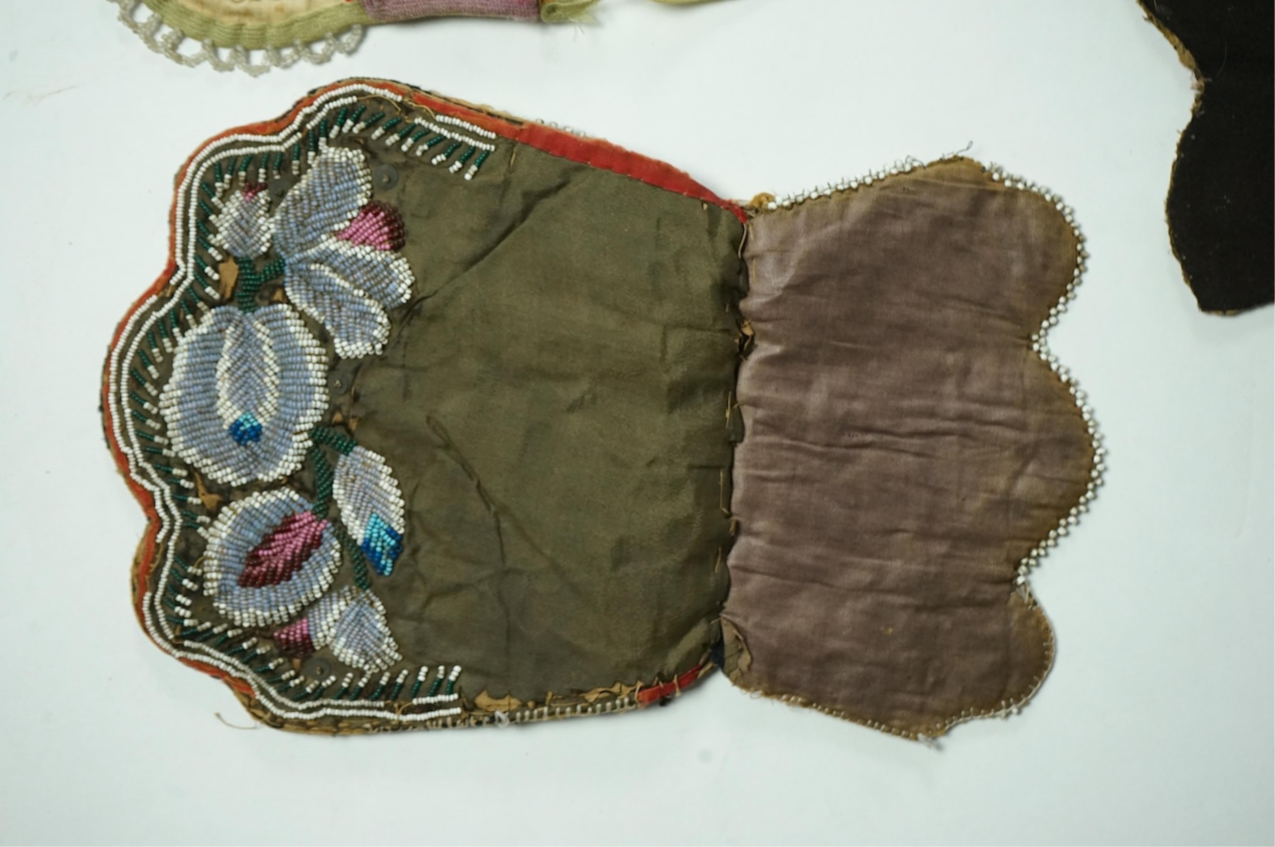 Five 19th century Native American beaded bags. Including a red felt coin pouch, three varying sized bags and a beaded panel.(5) Condition - four have damage to the fringing and beading and backing cloth. The light bag th